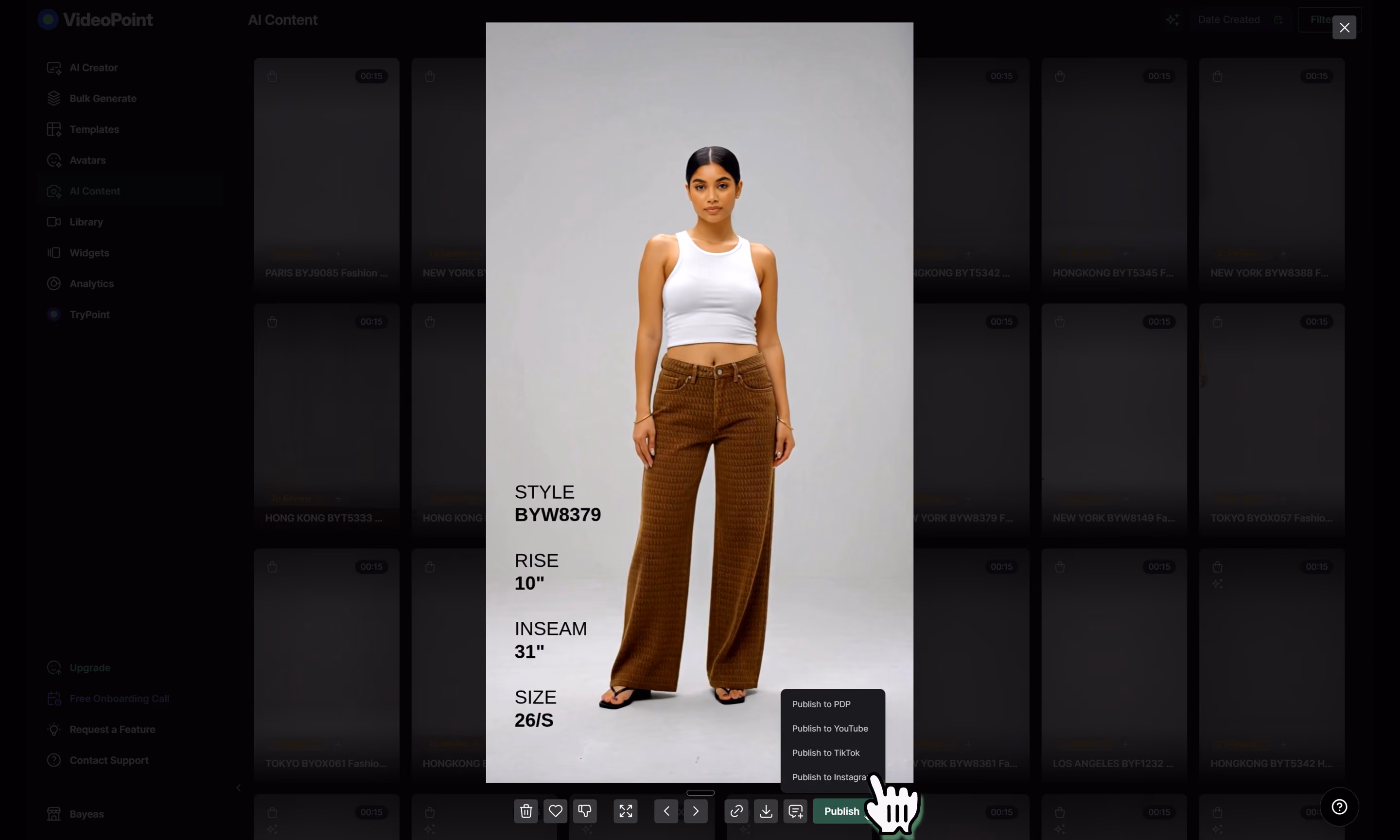 Woman wearing brown wide-leg pants with a white sleeveless crop top on a plain backdrop.